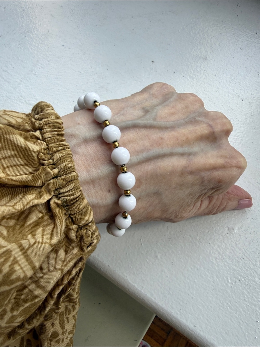 Monet Vintage White Beaded Bracelet with Gold Plated Spacers. Length 7.25 in.